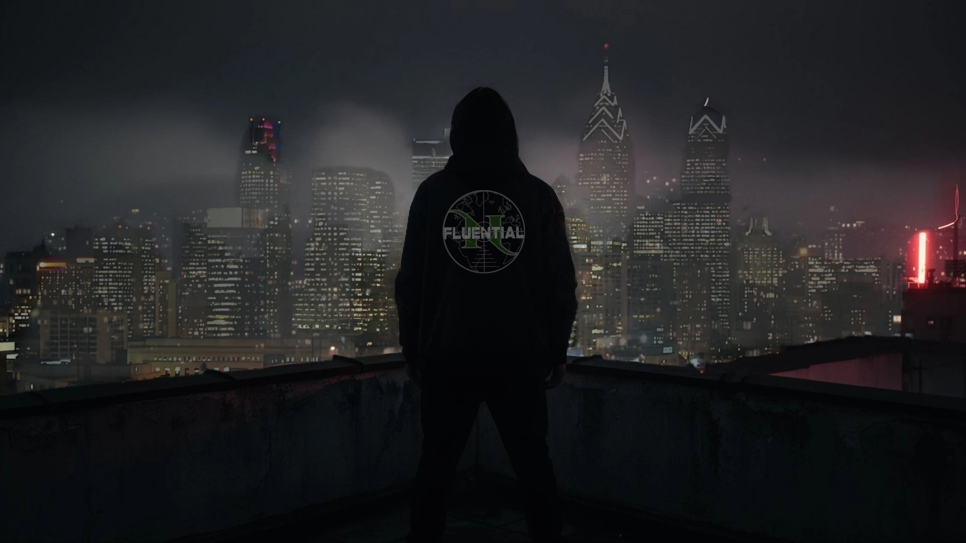 Nfluential hero — person in hoodie overlooking city skyline at night